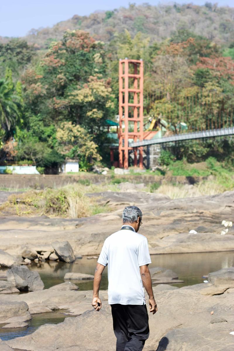 Father Xavier walking around at Athirappilly Falls, Ernakulam, Kerala, India