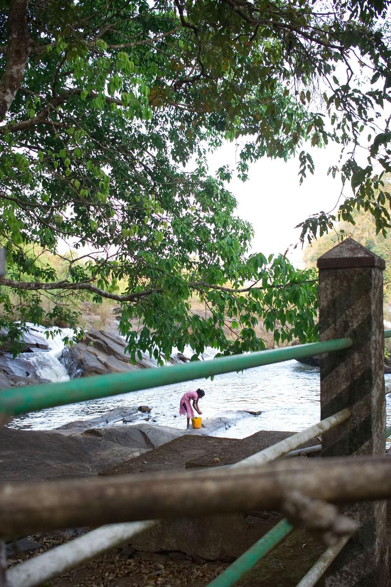 Woman washing clothes in the water, somewhere around Vazhachal Falls Ernakulam, Kerala, India