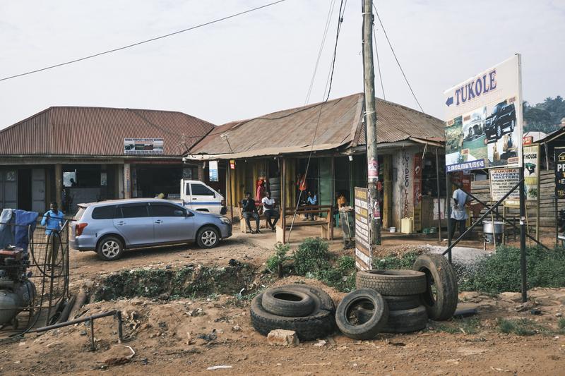 Stack of tires in front of store fronts, Uganda