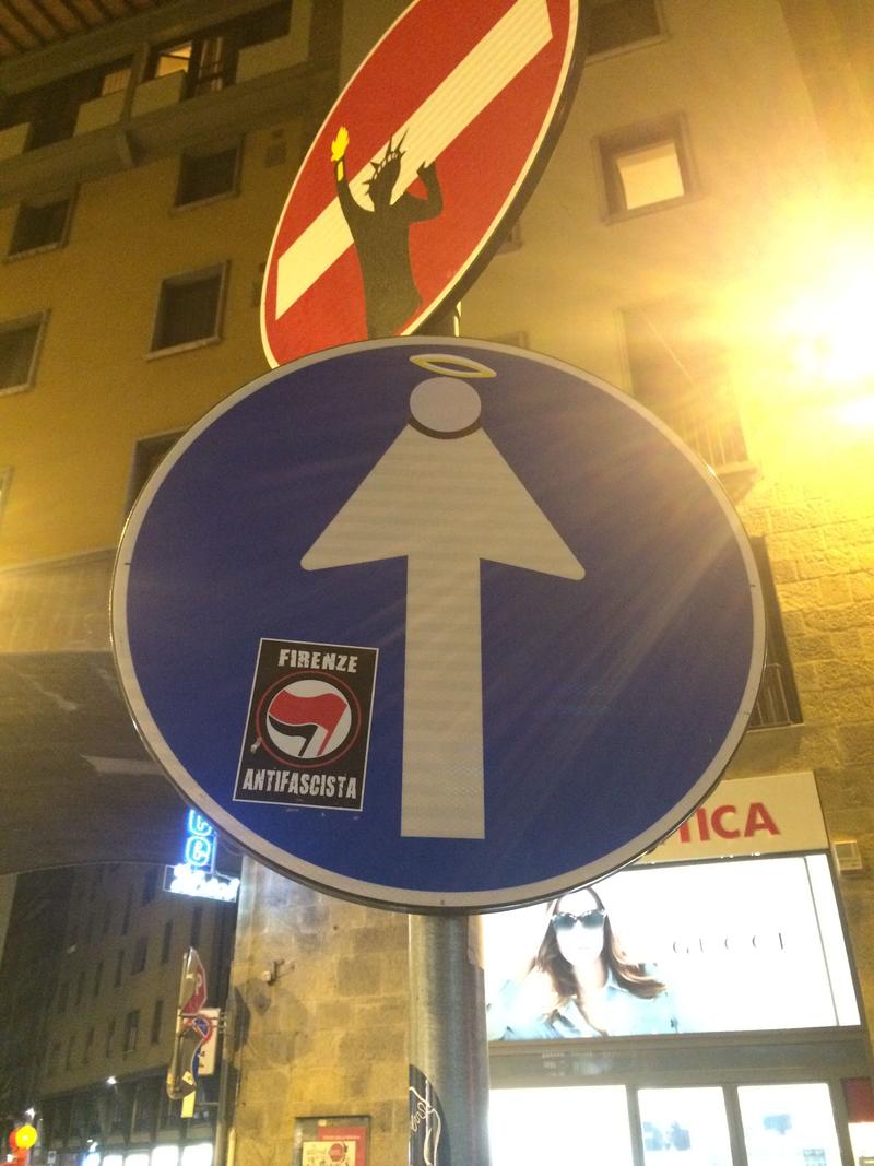 Creative street signage: lady liberty and the Saint, Florence, Italy