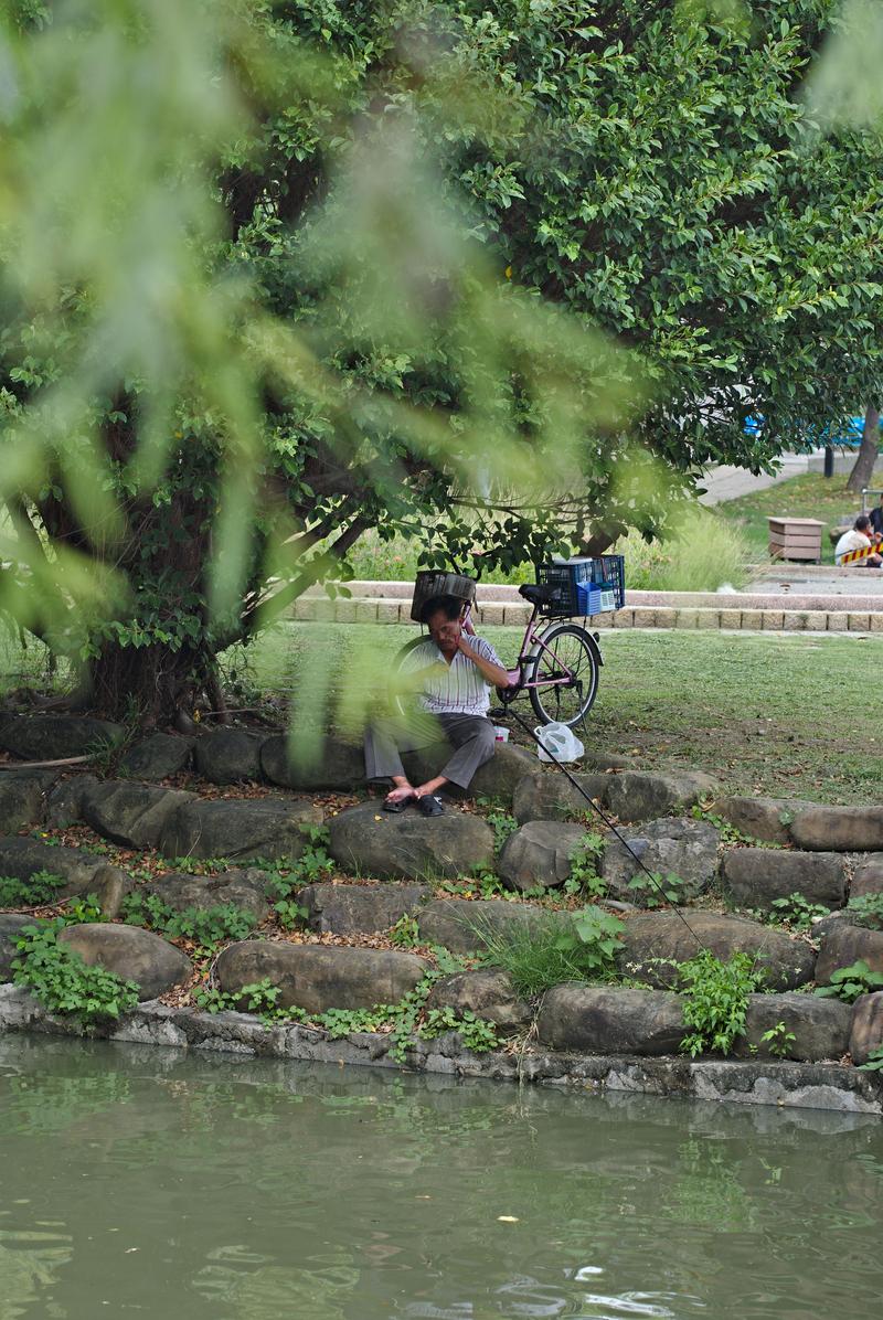 Fisherman baiting his hook near the Lotus Pond, Kaohsiung, Taiwan