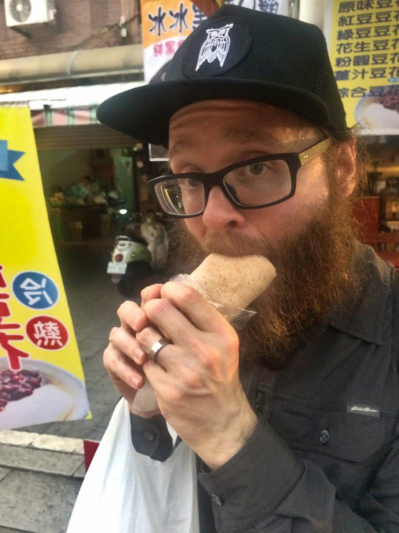 Eating the Ice Cream Peanut Wrap (2 scoops of ice cream, shaved peanut, and parsley ) on Cijin Island, Taiwan
