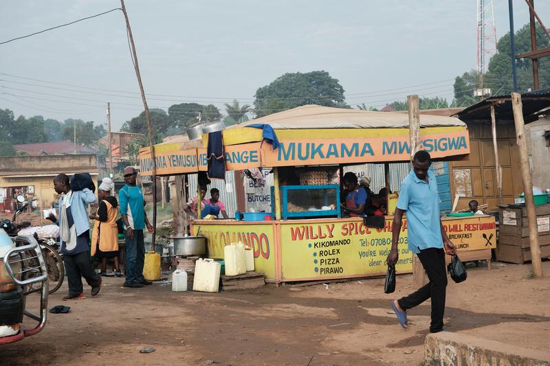People on the street in front of stores, Uganda