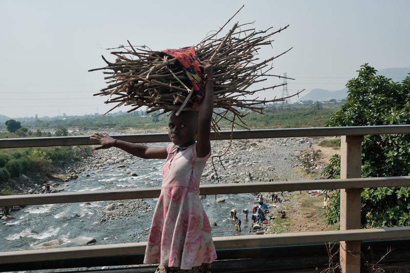 Kids carrying branch bundles on their heads, Uganda