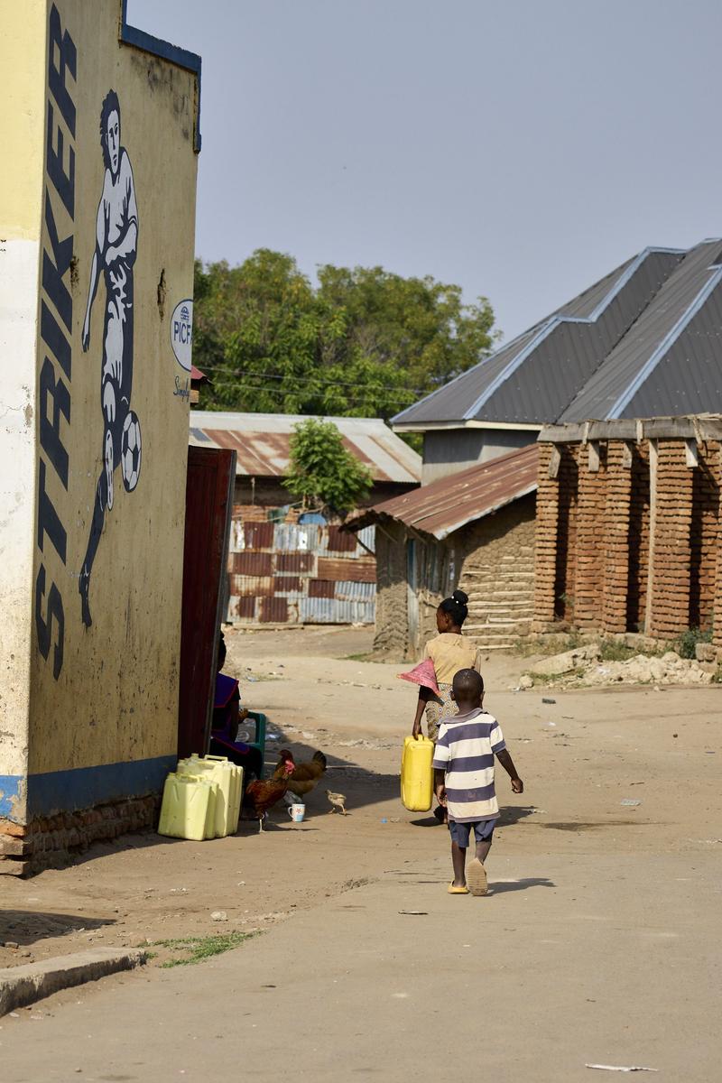 Mother and child walking home, Uganda