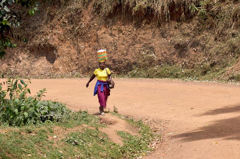 Person carrying a bucket on their head, Uganda